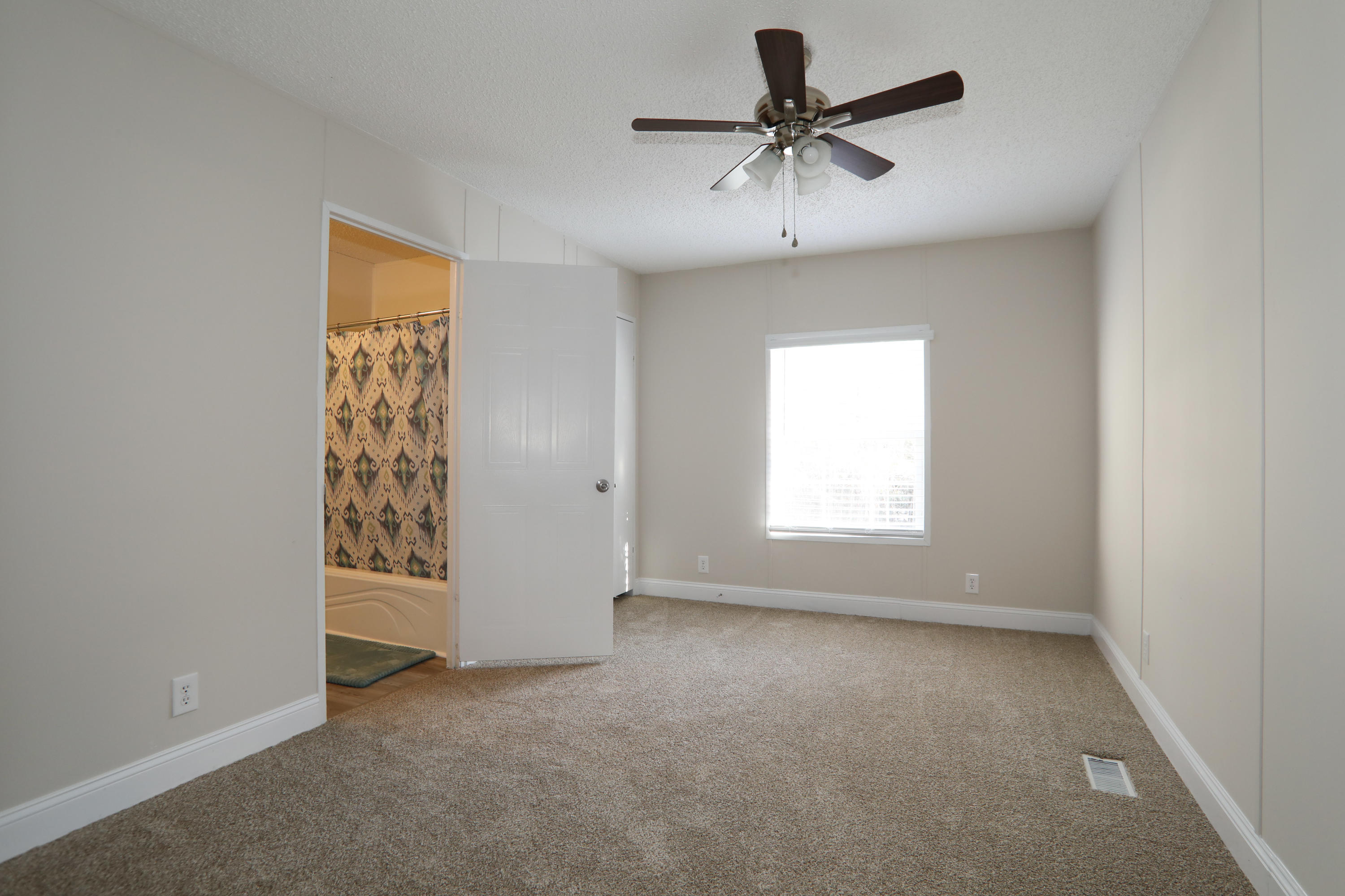 2080 West Kelley Road Baker, FL 32531 - Photo 15 of 20 an empty room with a window and a ceiling fan