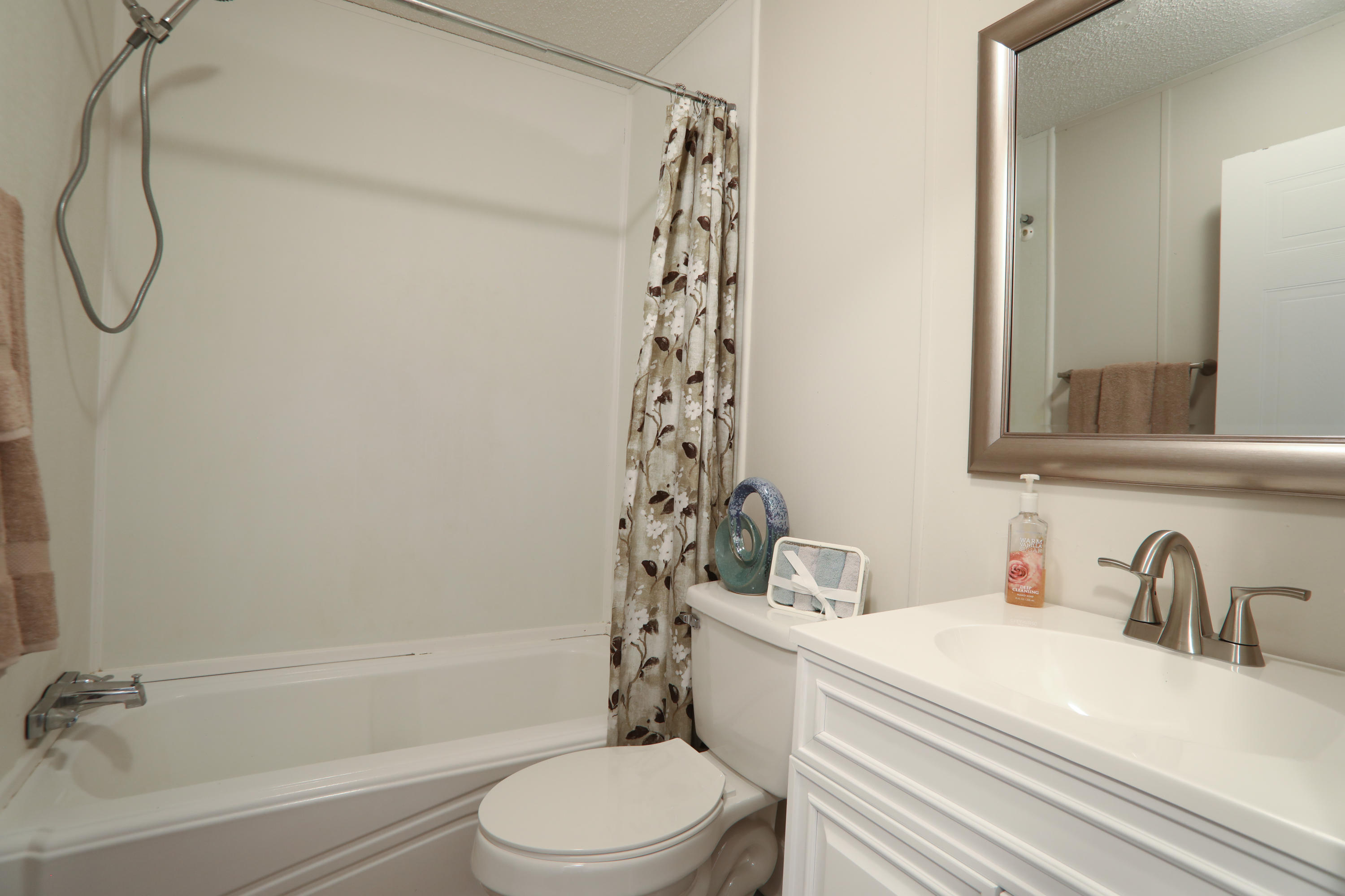 2080 West Kelley Road Baker, FL 32531 - Photo 17 of 20 a bathroom with a white sink a toilet and a bathtub
