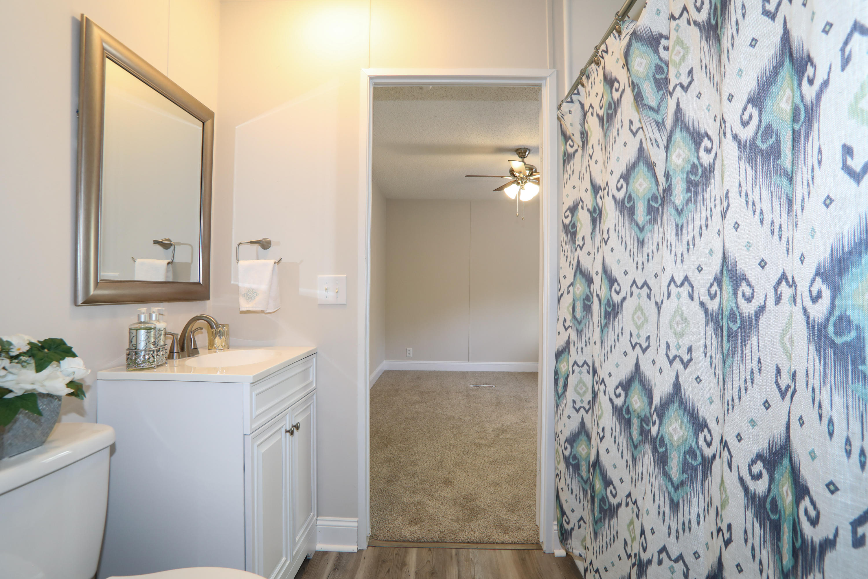2080 West Kelley Road Baker, FL 32531 - Photo 19 of 20 a bathroom with a sink and mirror with toilet