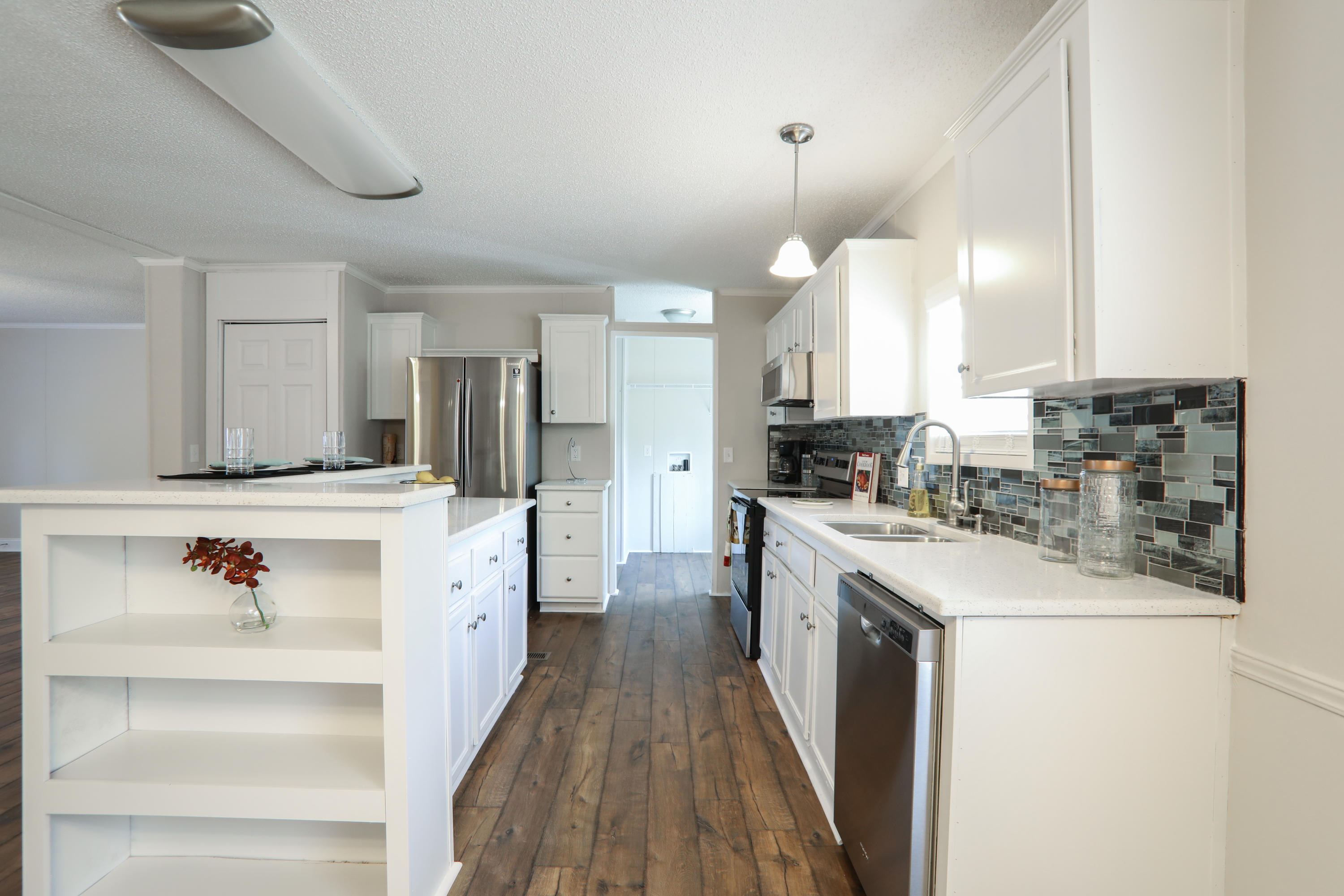 2080 West Kelley Road Baker, FL 32531 - Photo 2 of 20 a large kitchen with kitchen island white cabinets and stainless steel appliances