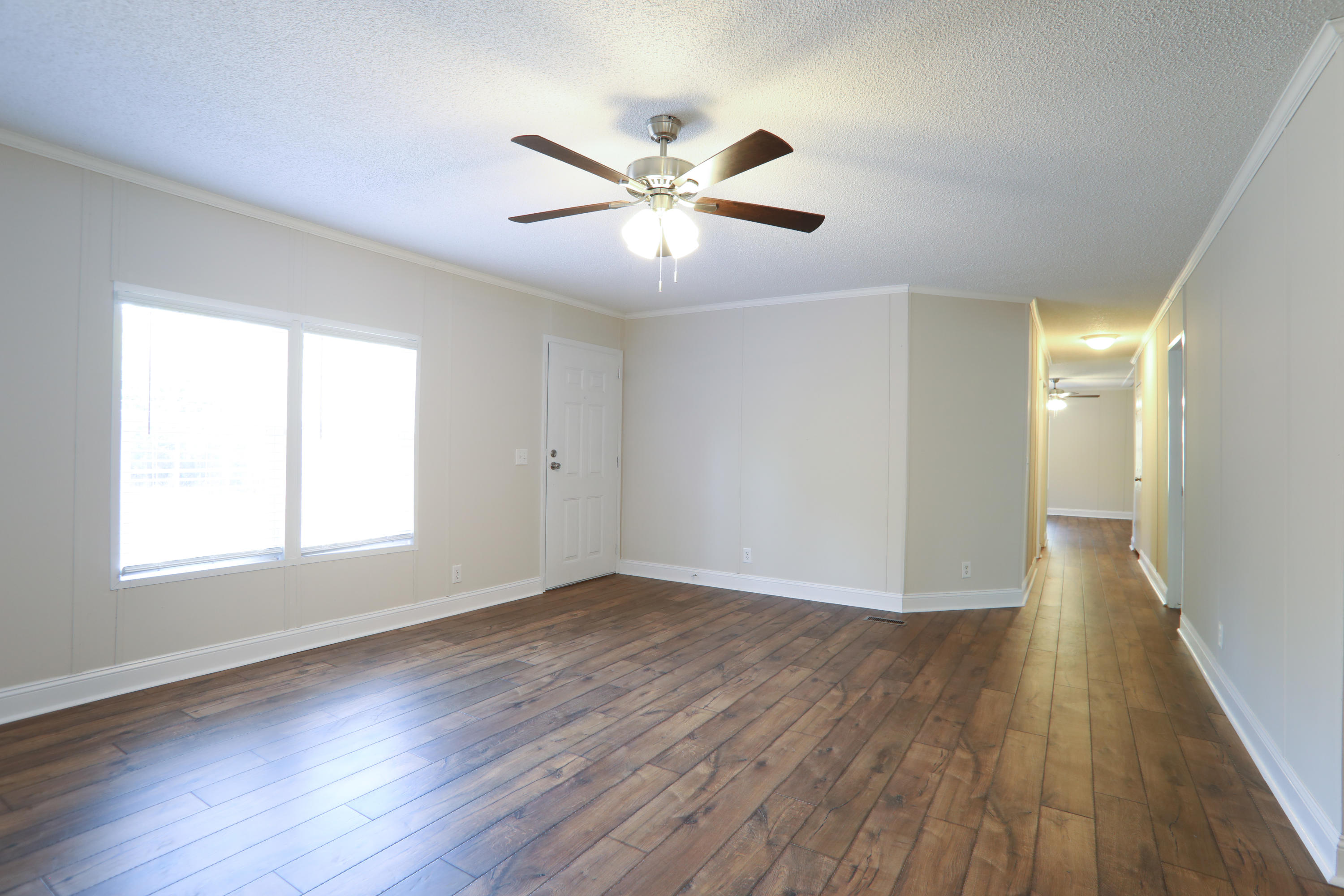 2080 West Kelley Road Baker, FL 32531 - Photo 9 of 20 a view of an empty room with wooden floor and a window
