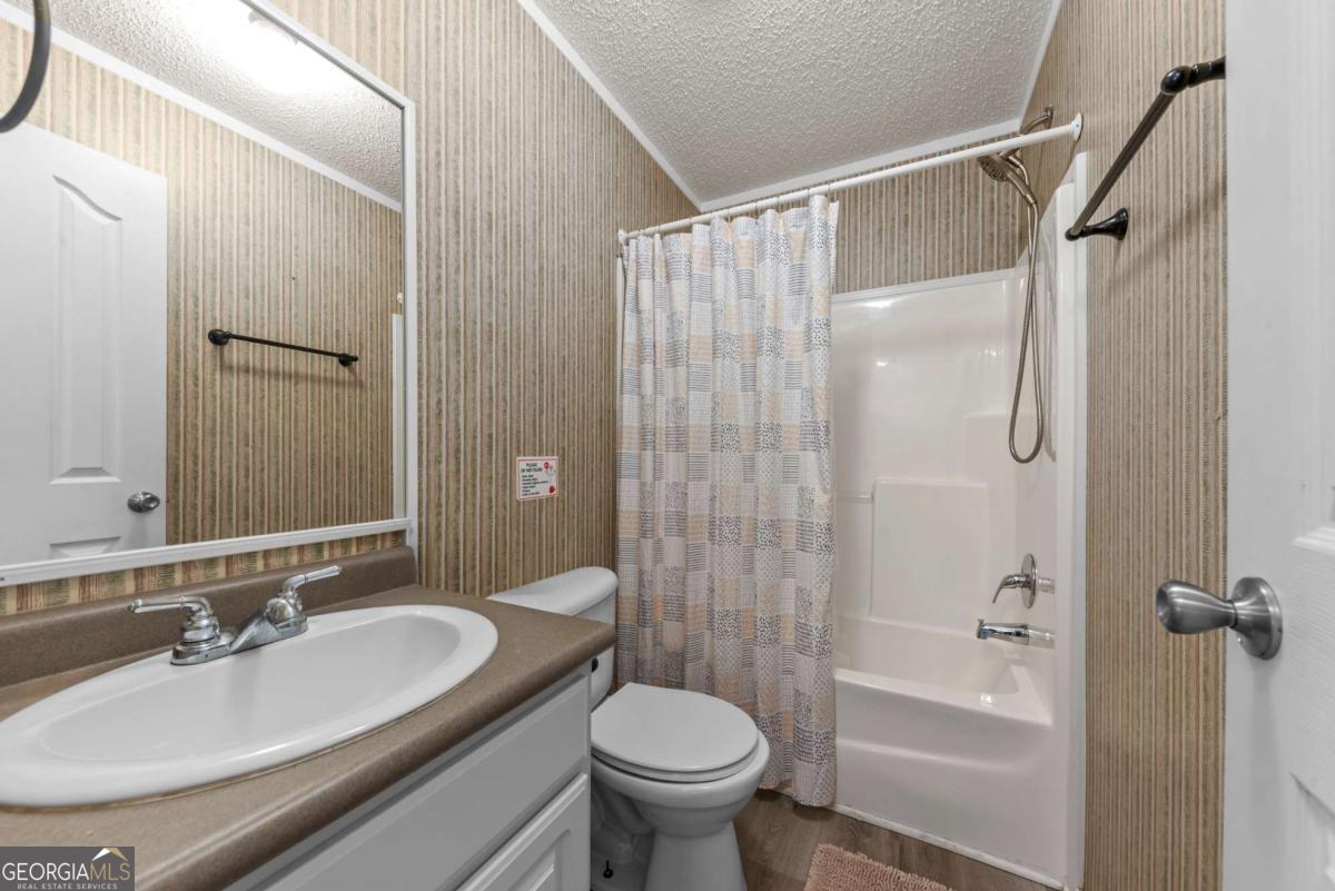 194 Phillips Road Eatonton, GA 31024 - Photo 33 of 57 a bathroom with a sink toilet and shower