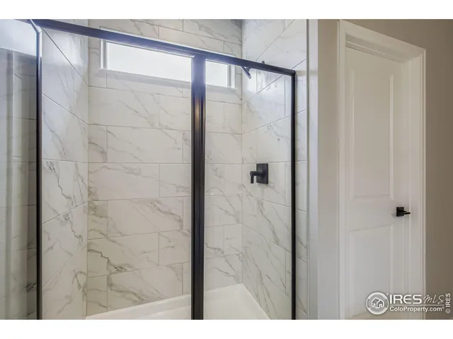 a bathroom with a glass shower door