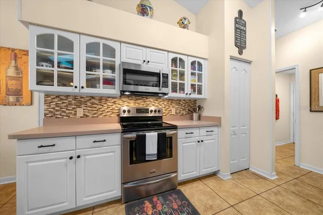 a kitchen with stainless steel appliances granite countertop a sink and a stove top oven with wooden floor