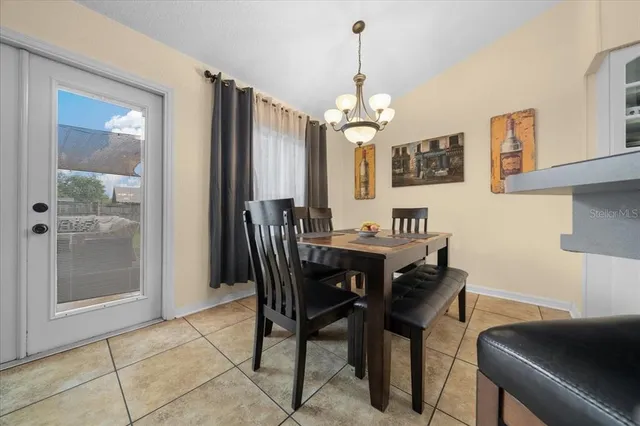 a view of a dining room with furniture and chandelier