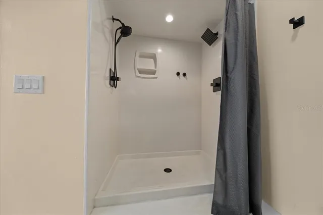 a bathroom with a bathtub a mirror a double vanity sink and vanity