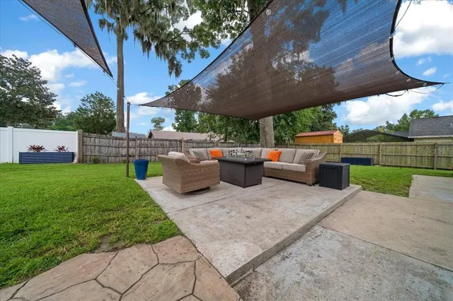 a view of a house with a backyard
