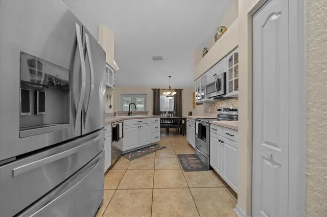 a kitchen with stainless steel appliances a stove sink and cabinets