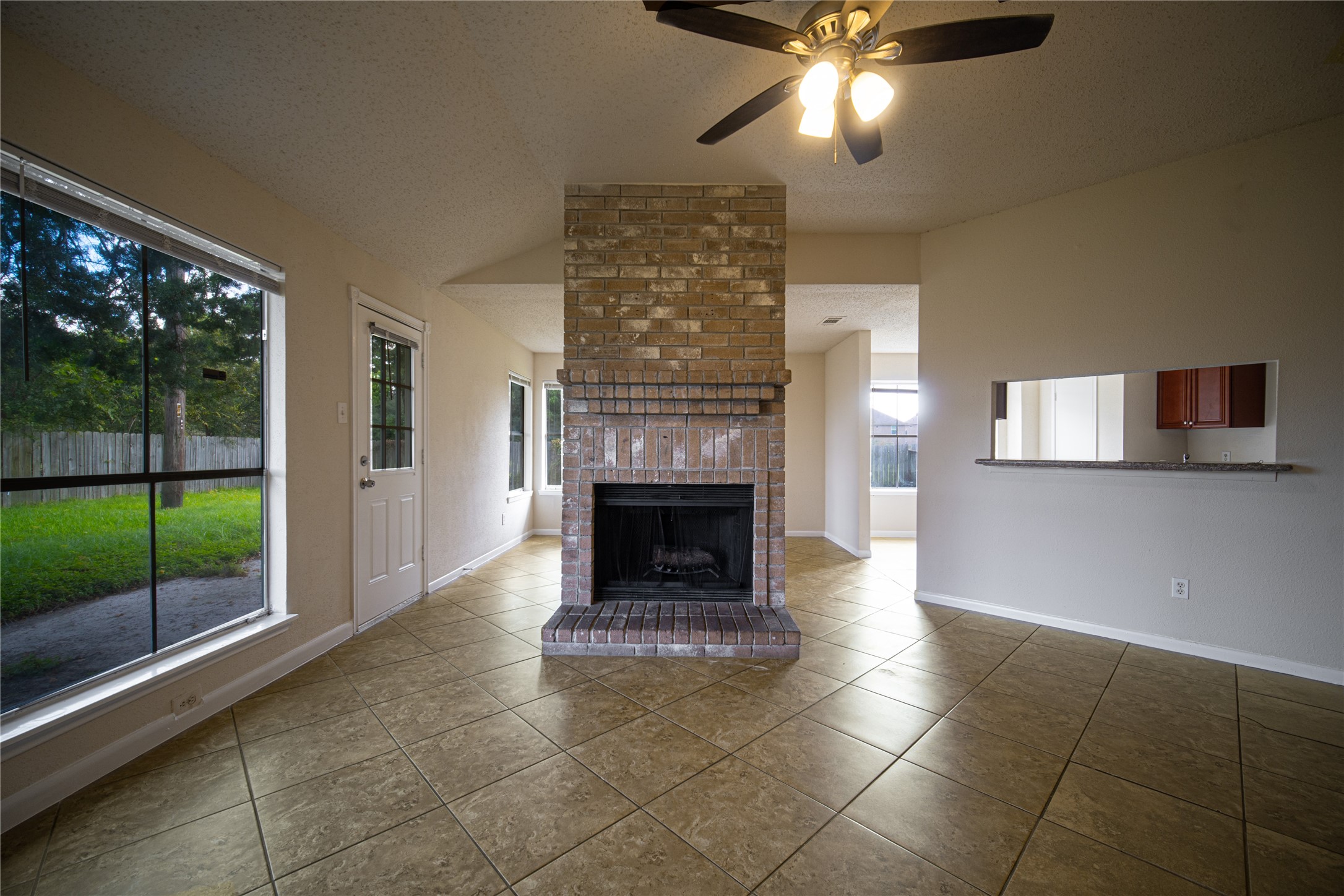 13314 Sablewood Lane Houston, TX 77014 - Photo 3 of 12 a living room with a fireplace and a floor to ceiling window