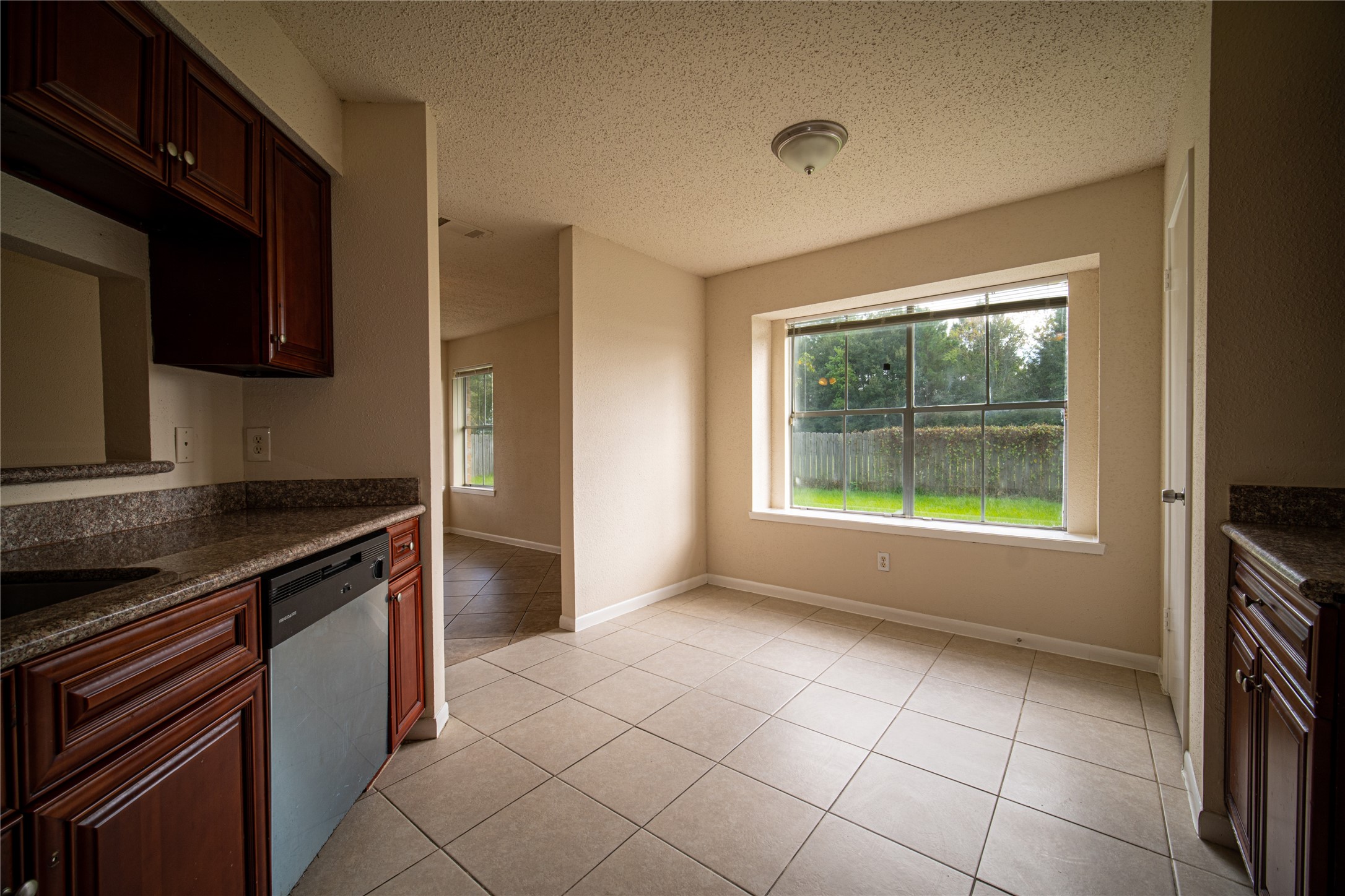13314 Sablewood Lane Houston, TX 77014 - Photo 6 of 12 a kitchen with granite countertop a sink and a stove top oven