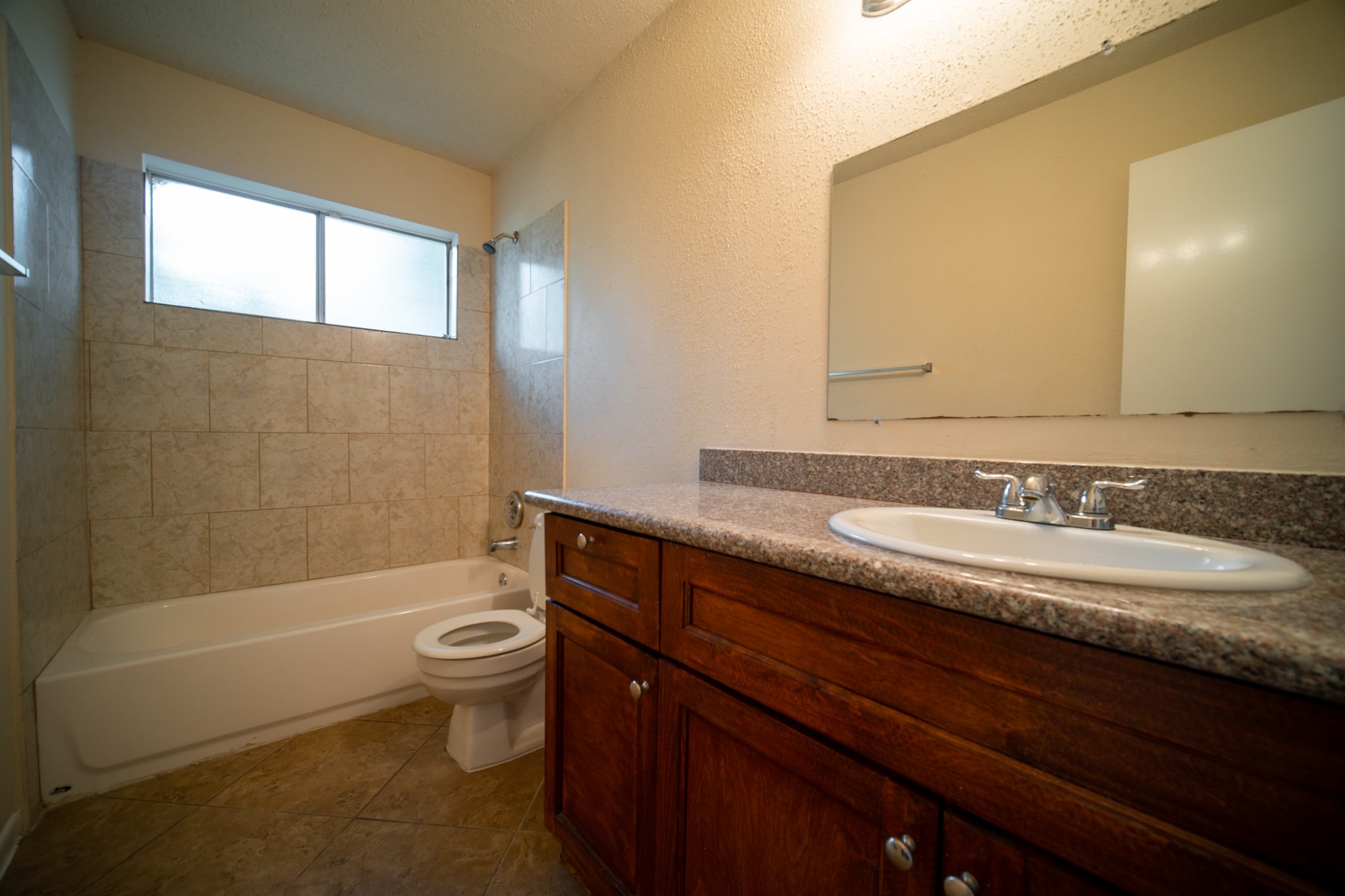 13314 Sablewood Lane Houston, TX 77014 - Photo 9 of 12 a bathroom with a granite countertop sink toilet and shower