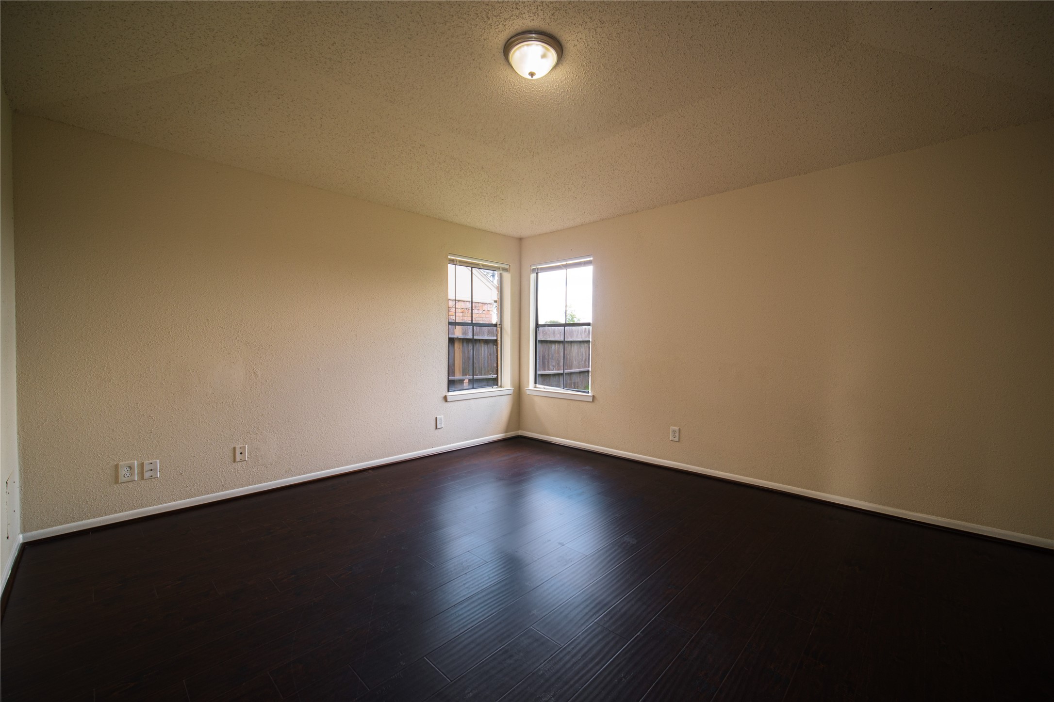 13314 Sablewood Lane Houston, TX 77014 - Photo 10 of 12 a view of an empty room with a window and wooden floor