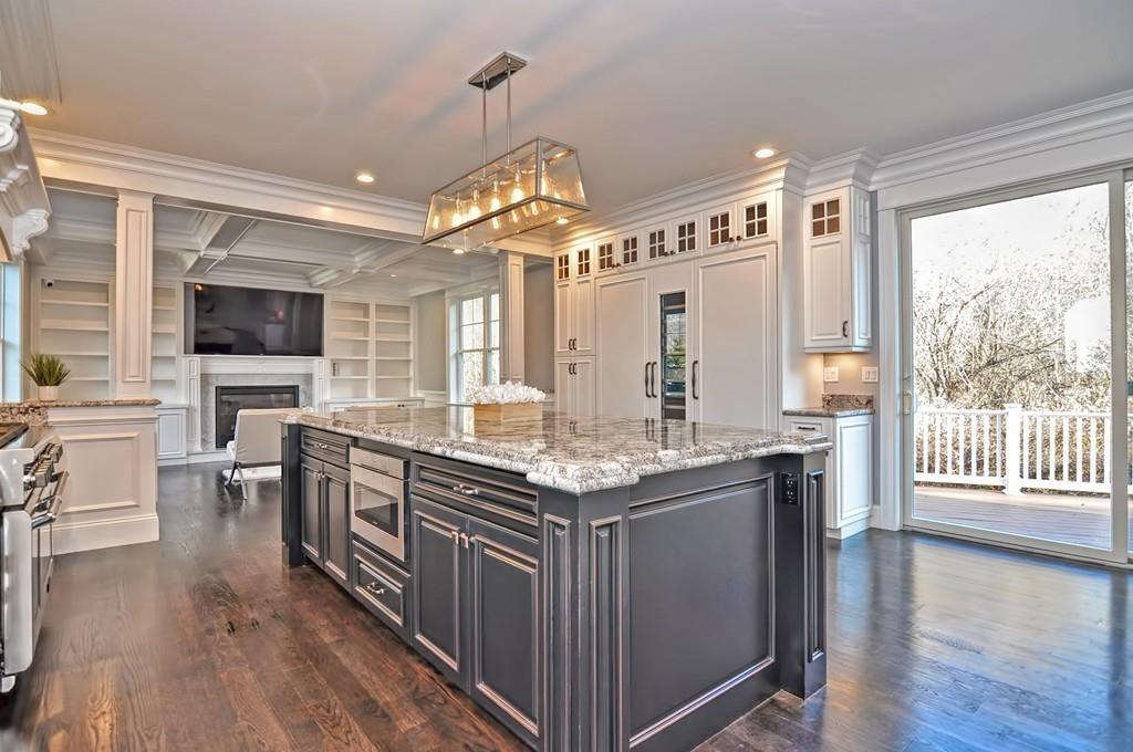 a kitchen with stainless steel appliances granite countertop a stove and a view of living room