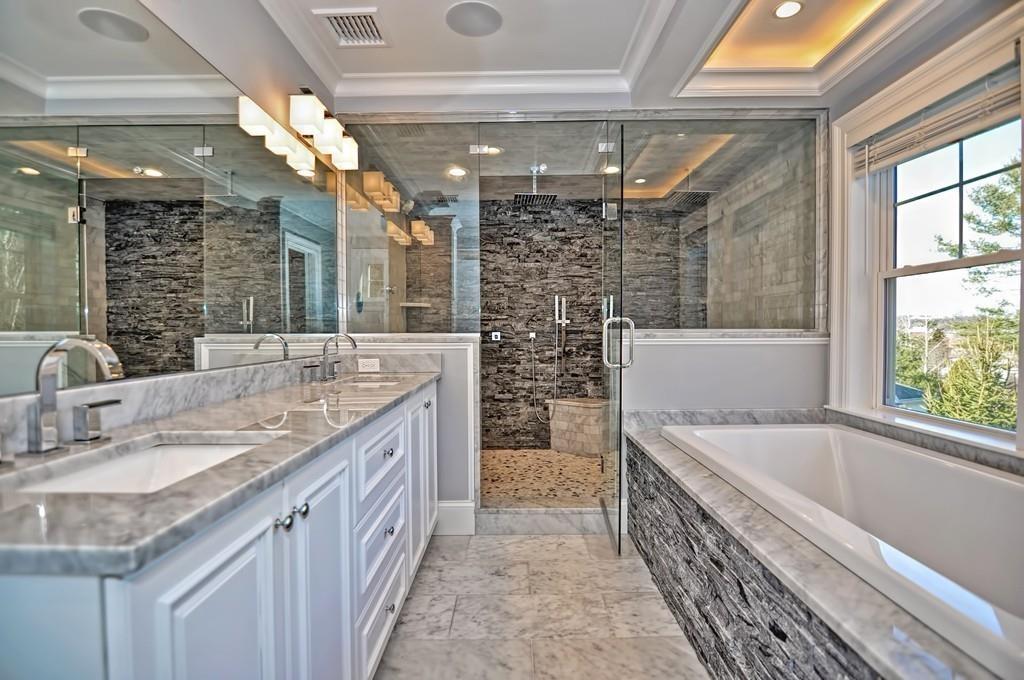 50 Beatrice Way Canton, MA 02021 - Photo 11 of 29 a bathroom with a granite countertop sink a large mirror and bathtub