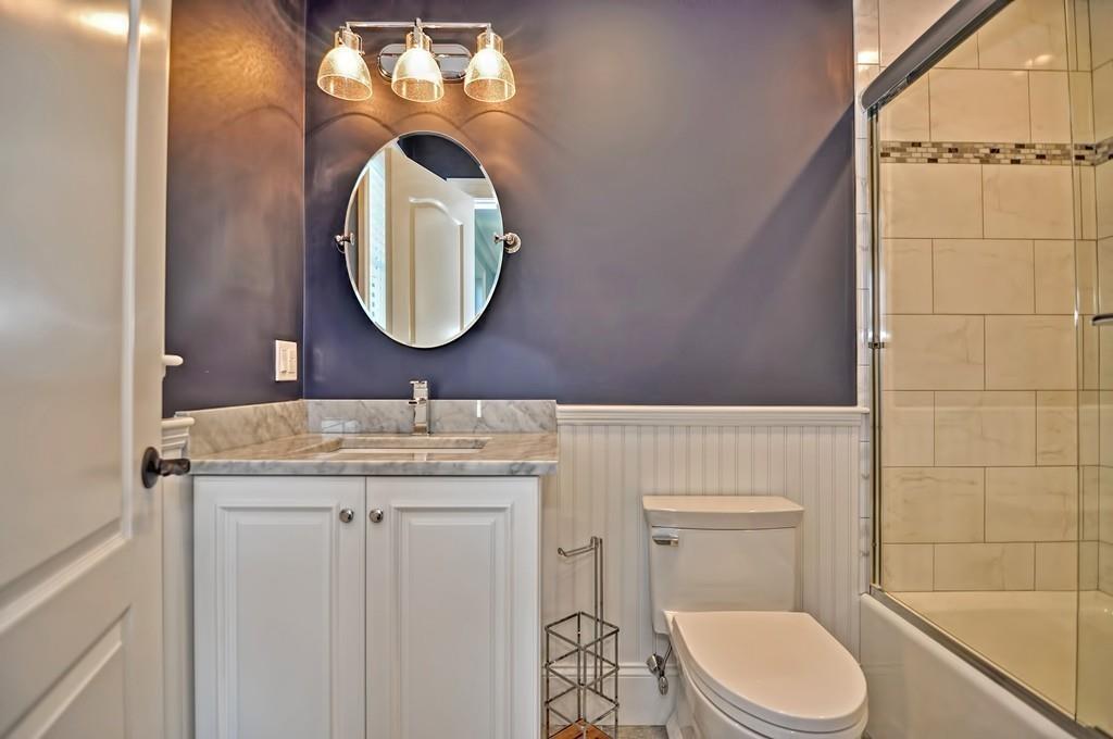 50 Beatrice Way Canton, MA 02021 - Photo 14 of 29 a bathroom with a toilet a sink and mirror
