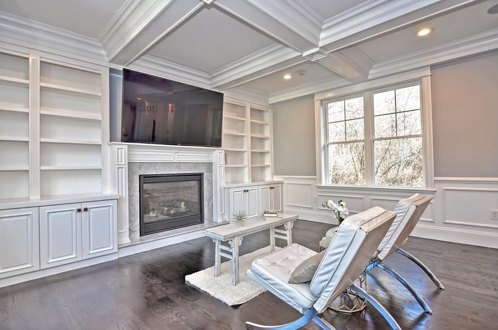 50 Beatrice Way Canton, MA 02021 - Photo 7 of 29 a living room with furniture a fireplace and a flat screen tv