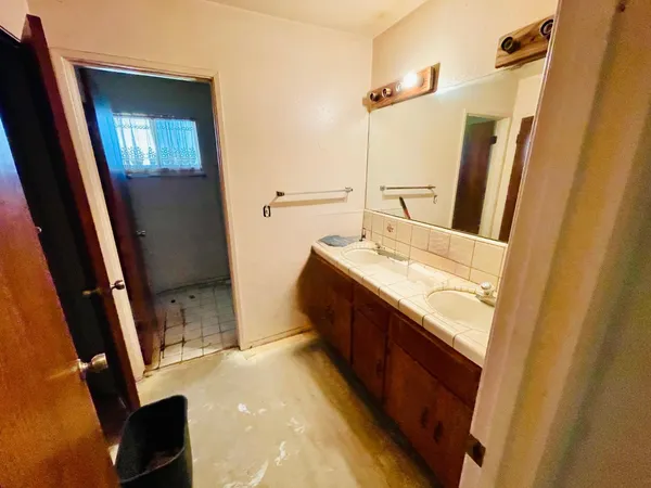 a bathroom with a sink a mirror and a vanity