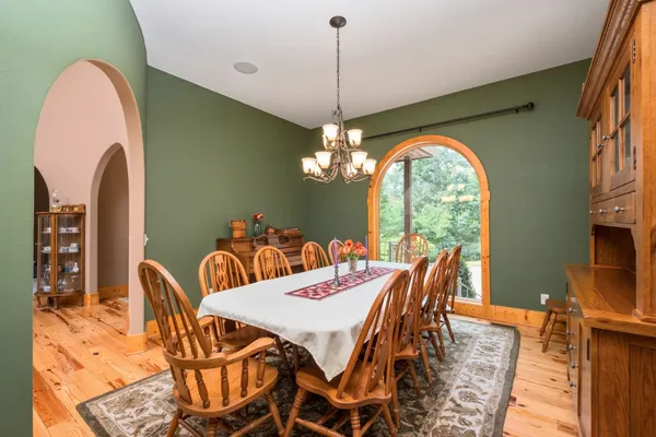 a living room with fireplace furniture and a chandelier