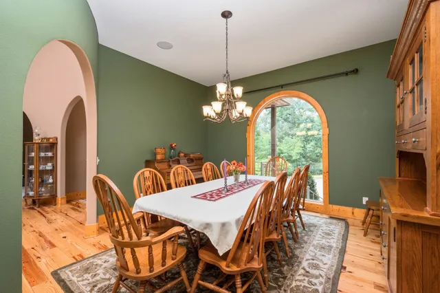 a living room with fireplace furniture and a chandelier
