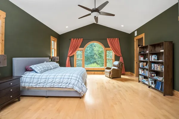 a kitchen with a refrigerator a stove a microwave and island with wooden floor