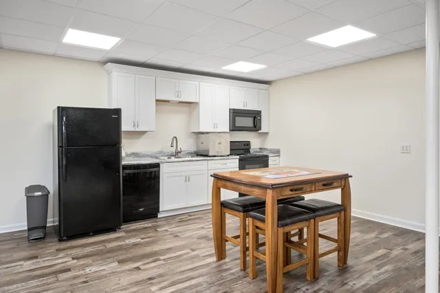 a kitchen with a refrigerator stove and cabinets