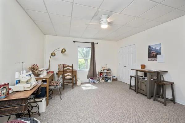 a view of a big house with a big yard and a large tree