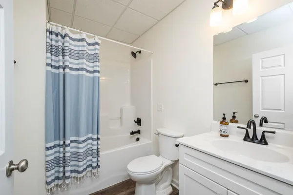 a roof deck with couch and chairs