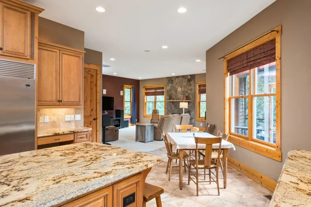 a large kitchen with kitchen island a sink stainless steel appliances and cabinets