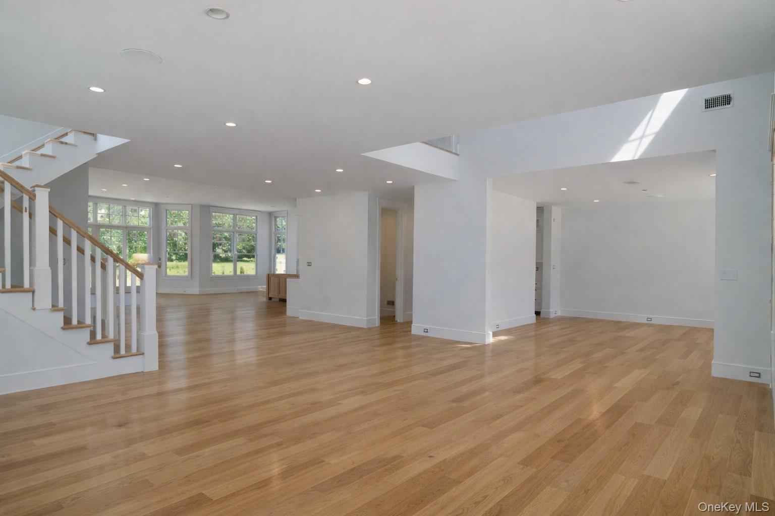 97 Aspatuck Road Westhampton Beach, NY 11978 - Photo 13 of 49 a view of an empty room with wooden floor and a window
