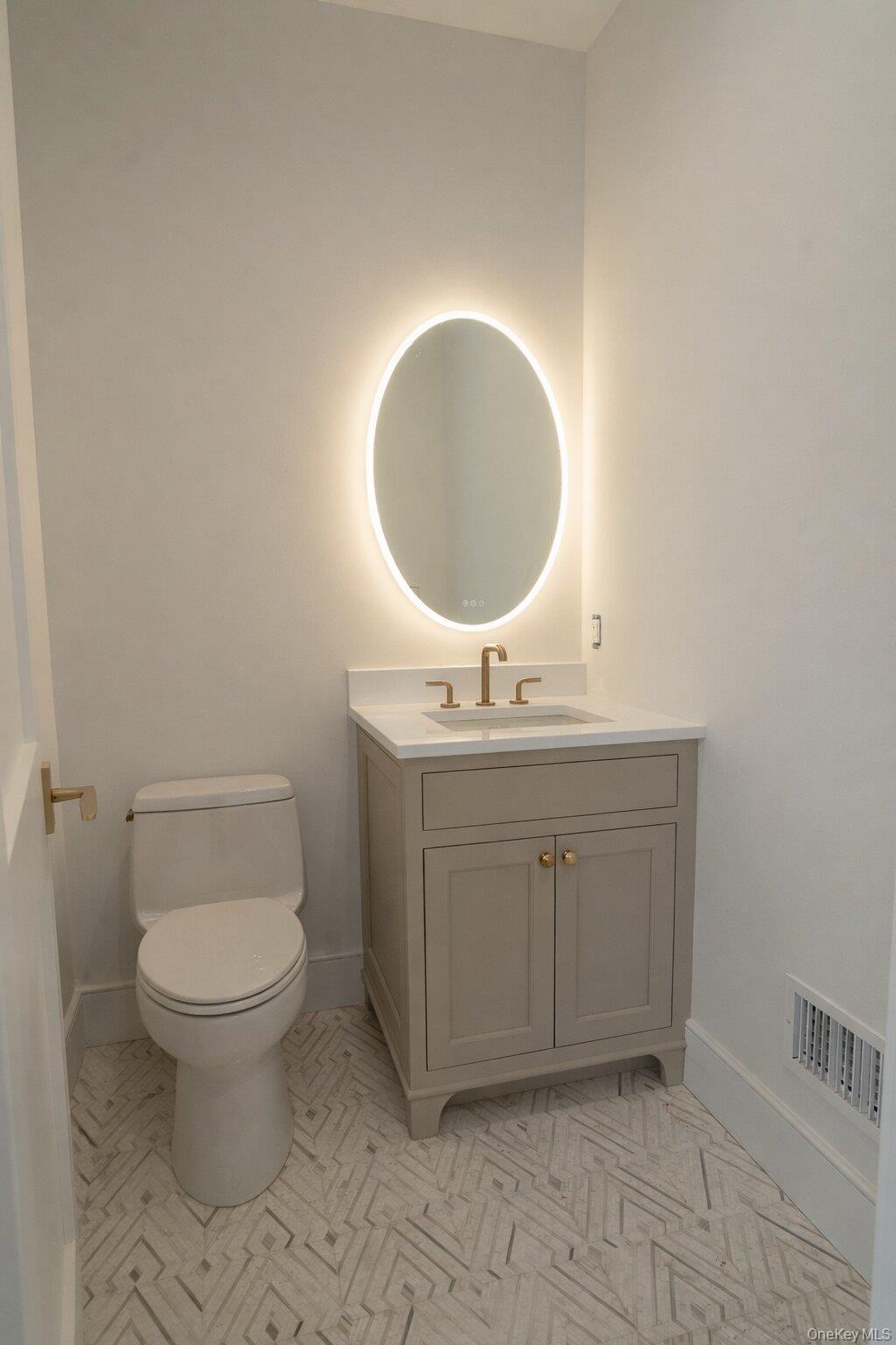97 Aspatuck Road Westhampton Beach, NY 11978 - Photo 19 of 49 a bathroom with a toilet sink and mirror
