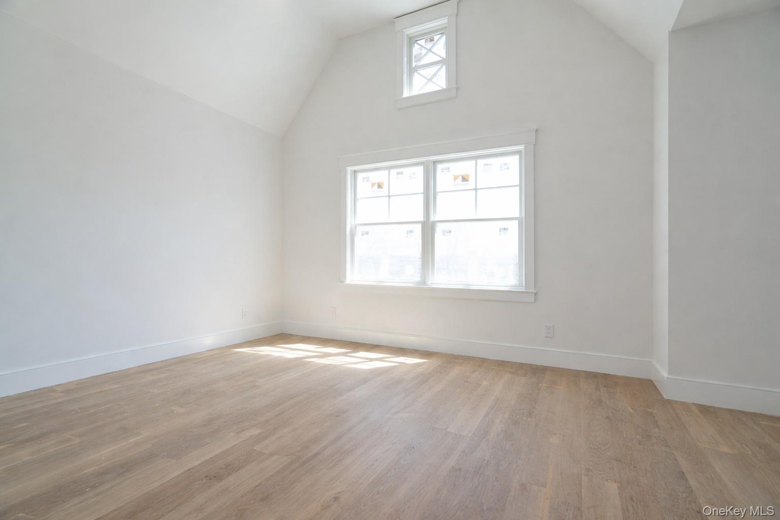 97 Aspatuck Road Westhampton Beach, NY 11978 - Photo 20 of 49 an empty room with wooden floor and windows