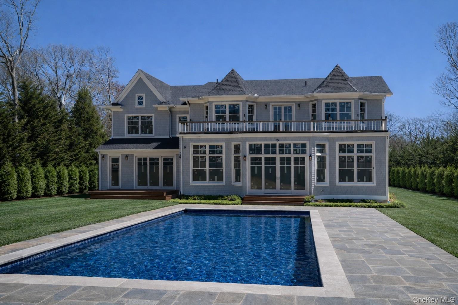 97 Aspatuck Road Westhampton Beach, NY 11978 - Photo 2 of 49 a front view of a building with garden