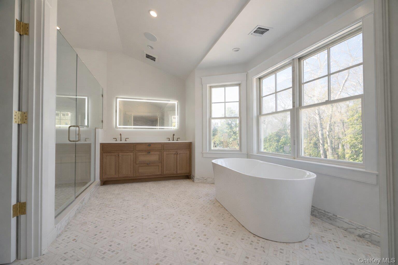 97 Aspatuck Road Westhampton Beach, NY 11978 - Photo 22 of 49 a bathroom with a tub a sink and mirror
