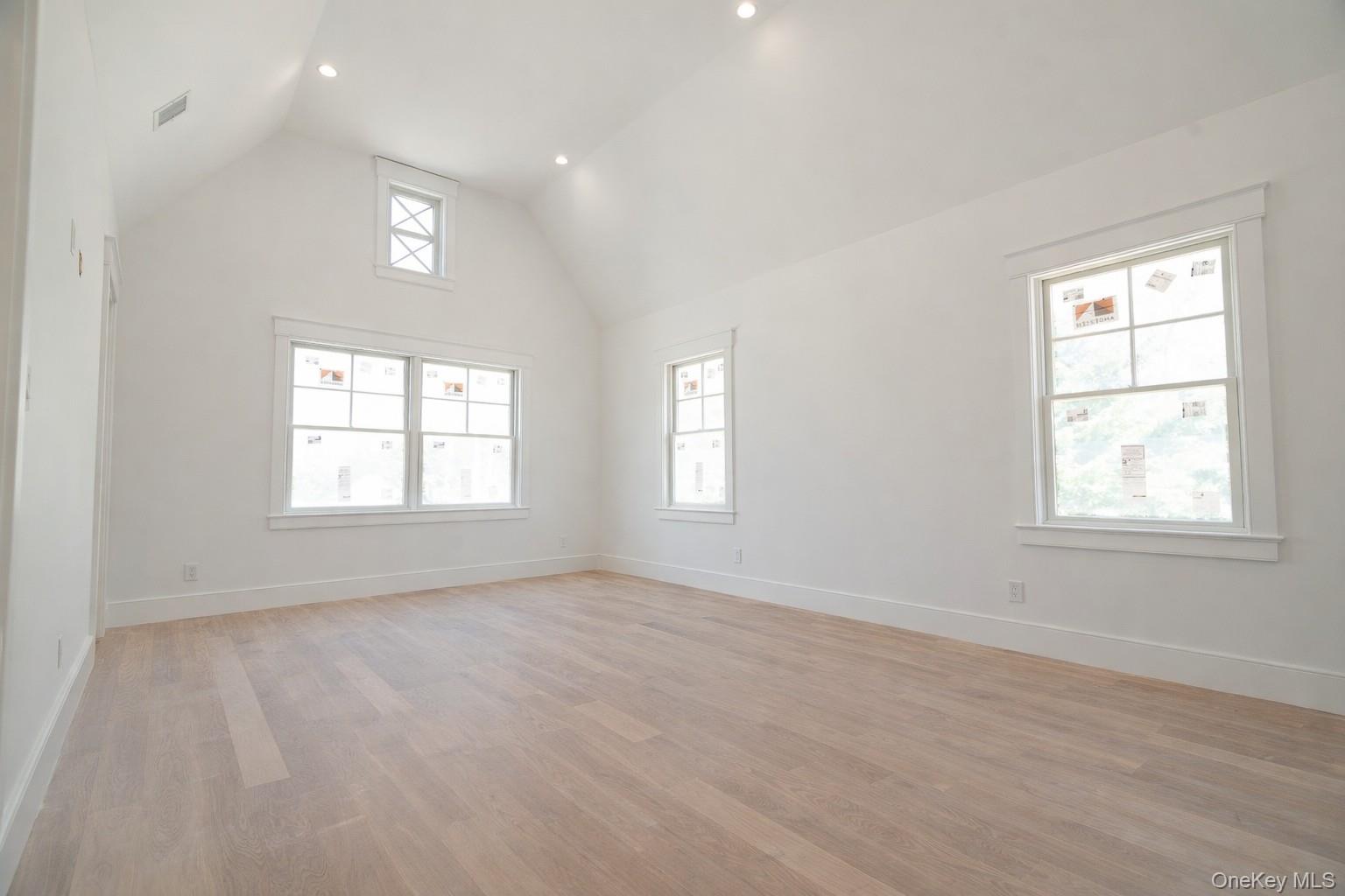 97 Aspatuck Road Westhampton Beach, NY 11978 - Photo 25 of 49 an empty room with wooden floor and windows