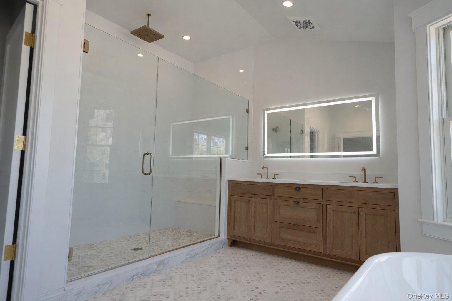 97 Aspatuck Road Westhampton Beach, NY 11978 - Photo 29 of 49 a bathroom with a double vanity sink and mirror with shower