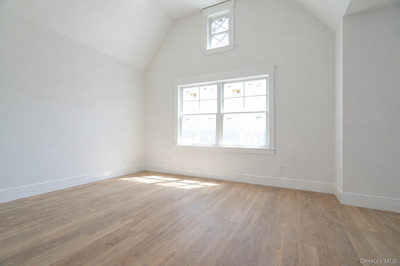 97 Aspatuck Road Westhampton Beach, NY 11978 - Photo 31 of 49 an empty room with wooden floor and windows