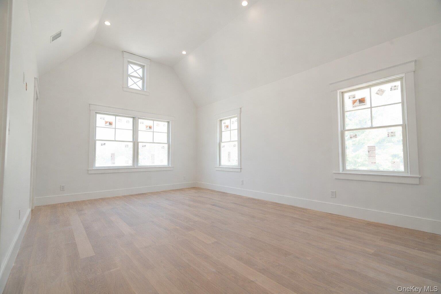 97 Aspatuck Road Westhampton Beach, NY 11978 - Photo 34 of 49 an empty room with wooden floor and windows