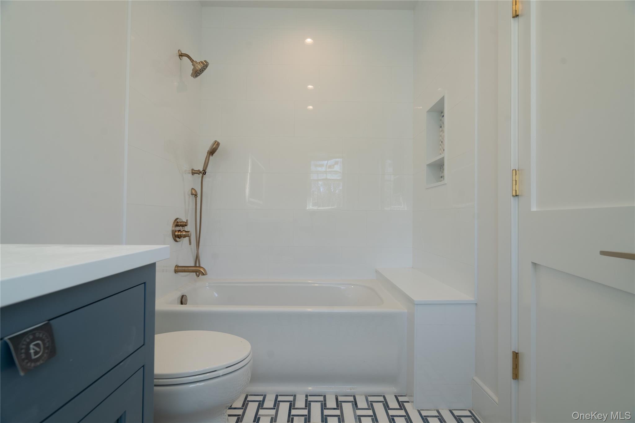 97 Aspatuck Road Westhampton Beach, NY 11978 - Photo 38 of 49 a bathroom with a granite countertop toilet a sink and bathtub