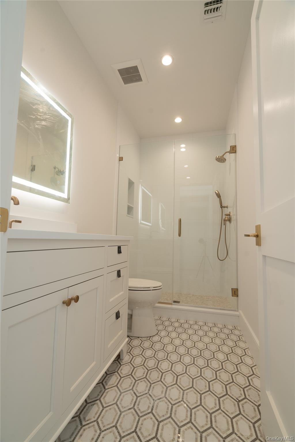 97 Aspatuck Road Westhampton Beach, NY 11978 - Photo 39 of 49 a bathroom with a granite countertop sink a toilet and shower