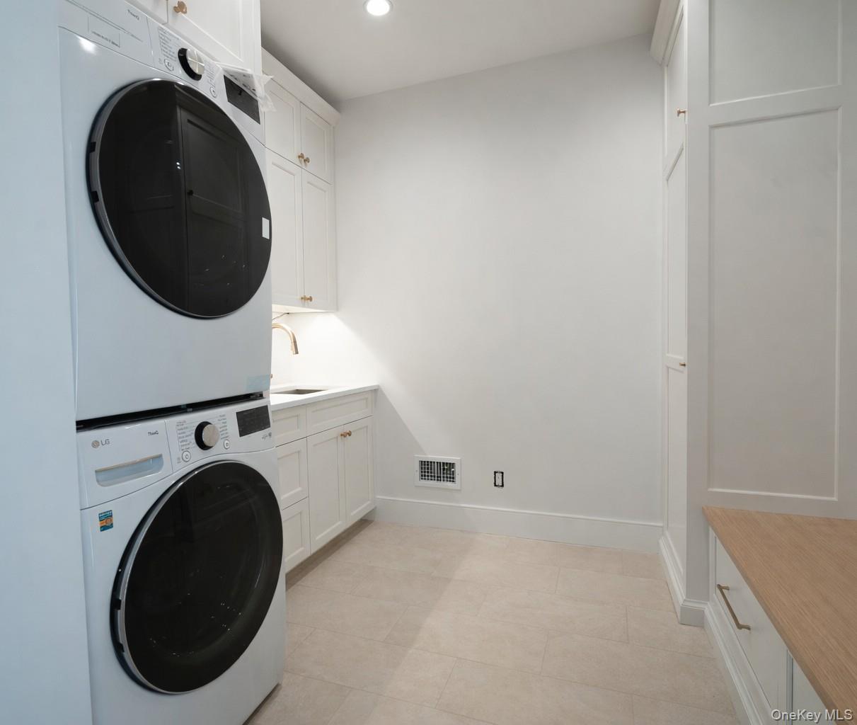 97 Aspatuck Road Westhampton Beach, NY 11978 - Photo 40 of 49 a view of a storage & utility room with dryer and washer