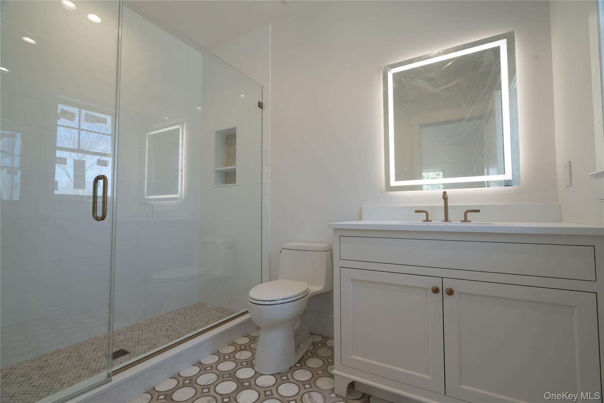 97 Aspatuck Road Westhampton Beach, NY 11978 - Photo 45 of 49 a bathroom with a sink a toilet and shower