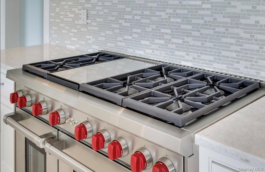 97 Aspatuck Road Westhampton Beach, NY 11978 - Photo 9 of 49 a close up of a stove top oven sitting next to a window