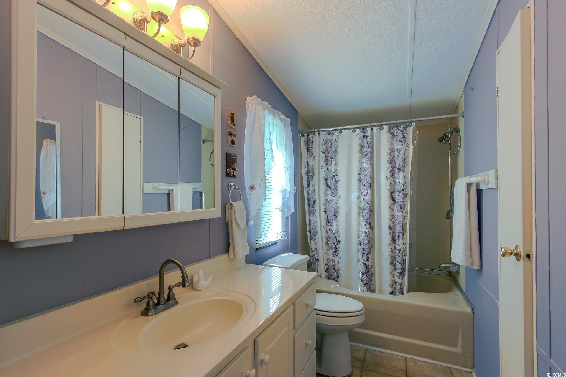 163 Crooked Island Circle Murrells Inlet, SC 29576 - Photo 18 of 40 Bathroom featuring shower / bath combination with curtain, vanity, and light tile patterned floors