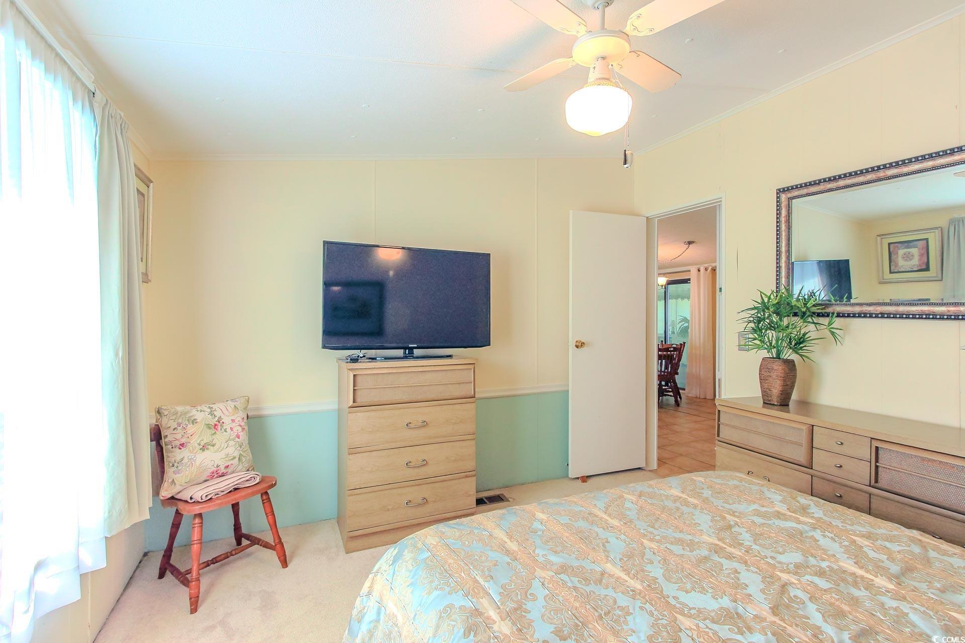 163 Crooked Island Circle Murrells Inlet, SC 29576 - Photo 20 of 40 Bedroom with multiple windows, light colored carpet, ornamental molding, and a ceiling fan