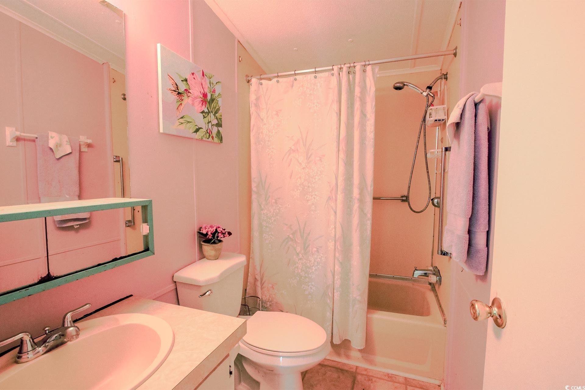 163 Crooked Island Circle Murrells Inlet, SC 29576 - Photo 21 of 40 Bathroom featuring vanity, shower / bath combo with shower curtain, and tile patterned floors