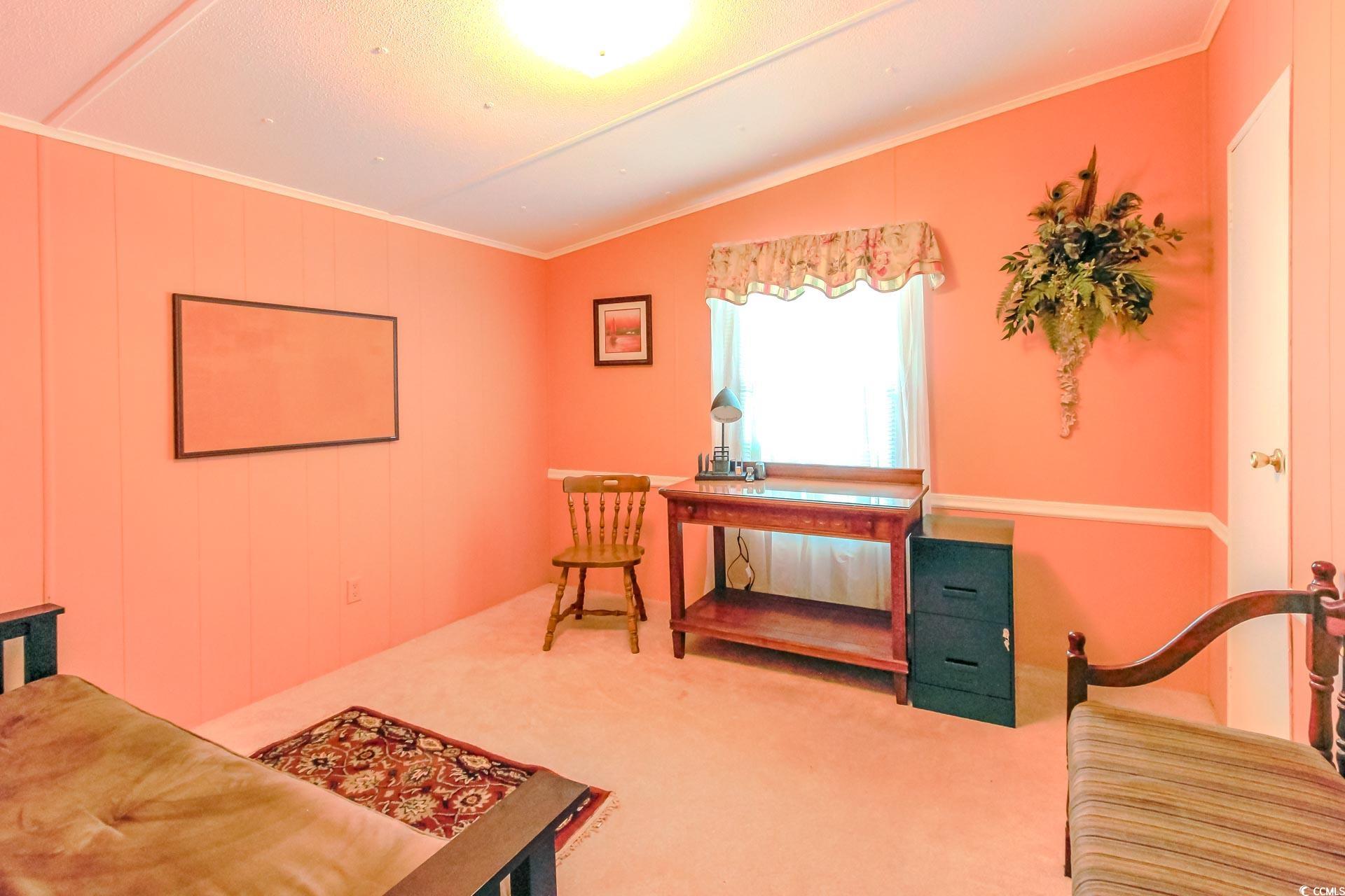 163 Crooked Island Circle Murrells Inlet, SC 29576 - Photo 22 of 40 Sitting room with ornamental molding, vaulted ceiling, and carpet