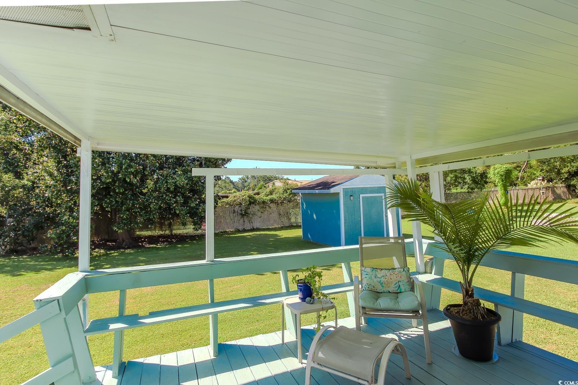 163 Crooked Island Circle Murrells Inlet, SC 29576 - Photo 32 of 40 Deck with a storage shed and a fenced backyard