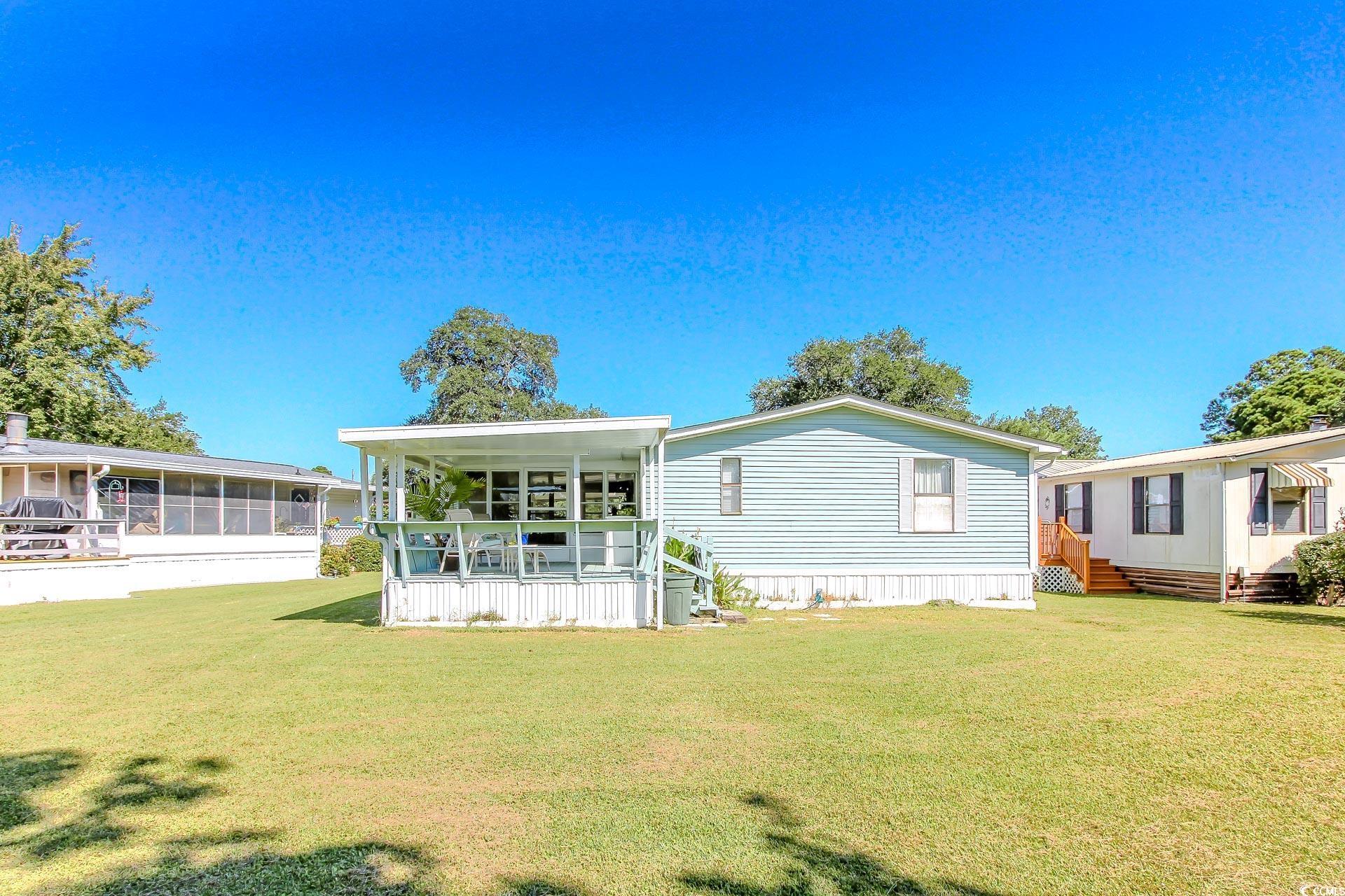 163 Crooked Island Circle Murrells Inlet, SC 29576 - Photo 33 of 40 Rear view of house featuring a yard