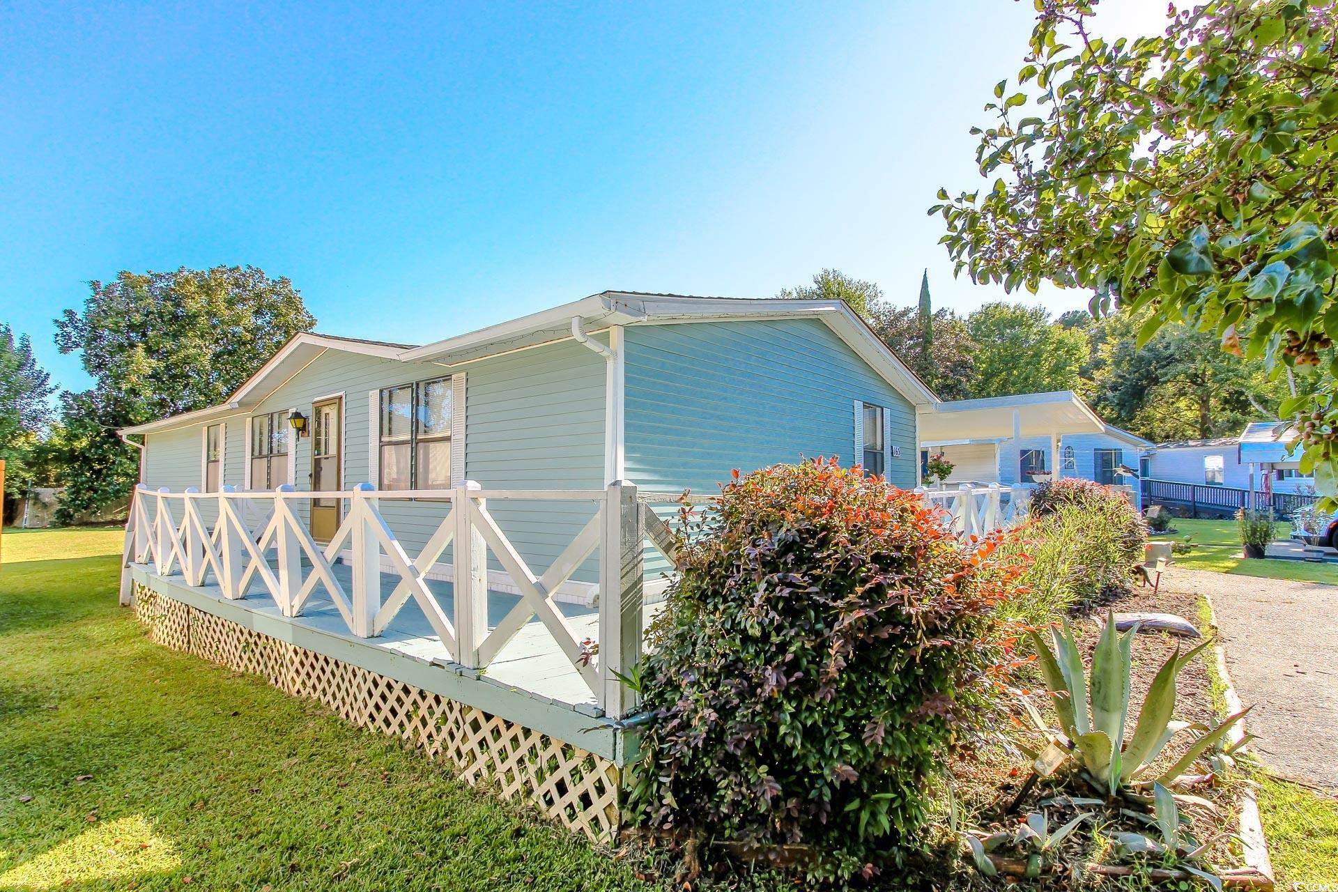 163 Crooked Island Circle Murrells Inlet, SC 29576 - Photo 34 of 40 View of property exterior with a lawn and a wooden deck
