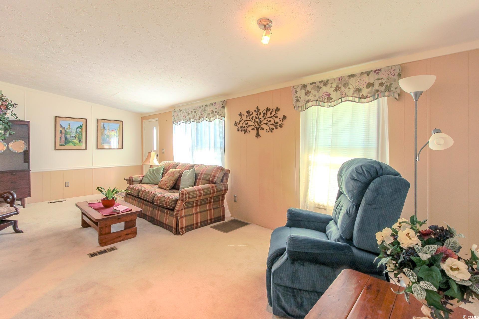 163 Crooked Island Circle Murrells Inlet, SC 29576 - Photo 6 of 40 Carpeted living room with a textured ceiling